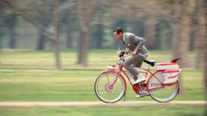 Pee Wee experiences the freedom of a two-wheeler.